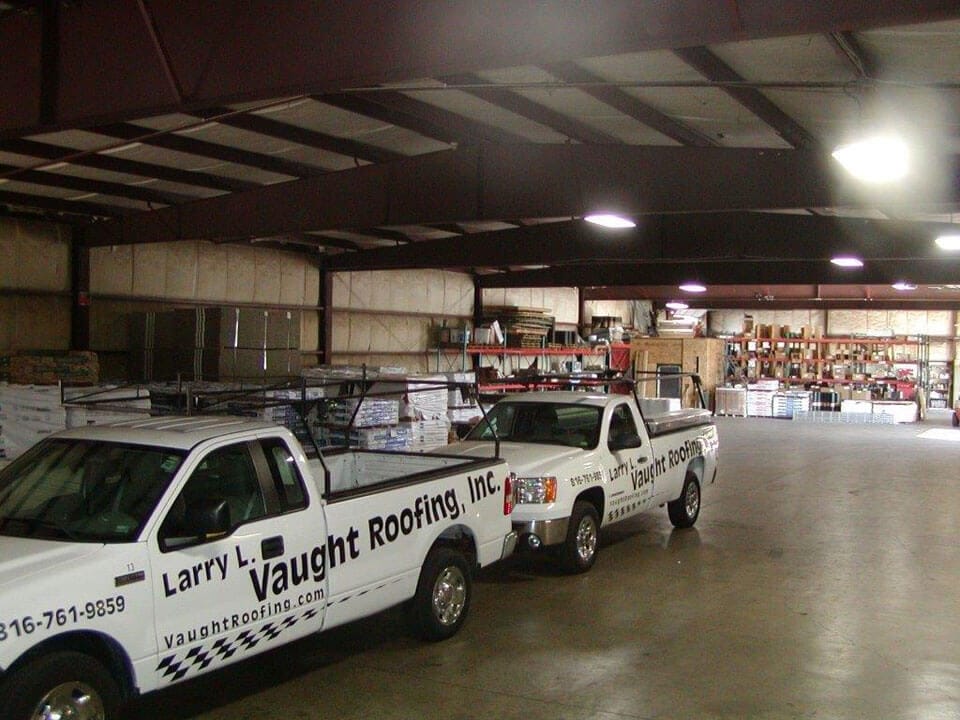 Vaught Roofing Trucks with logos