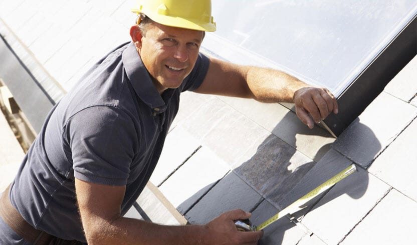 Roofing contractor installing new roof