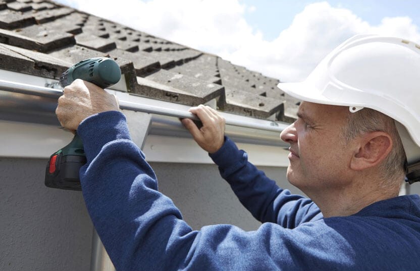 Roofing contractor Kansas City installing new gutters